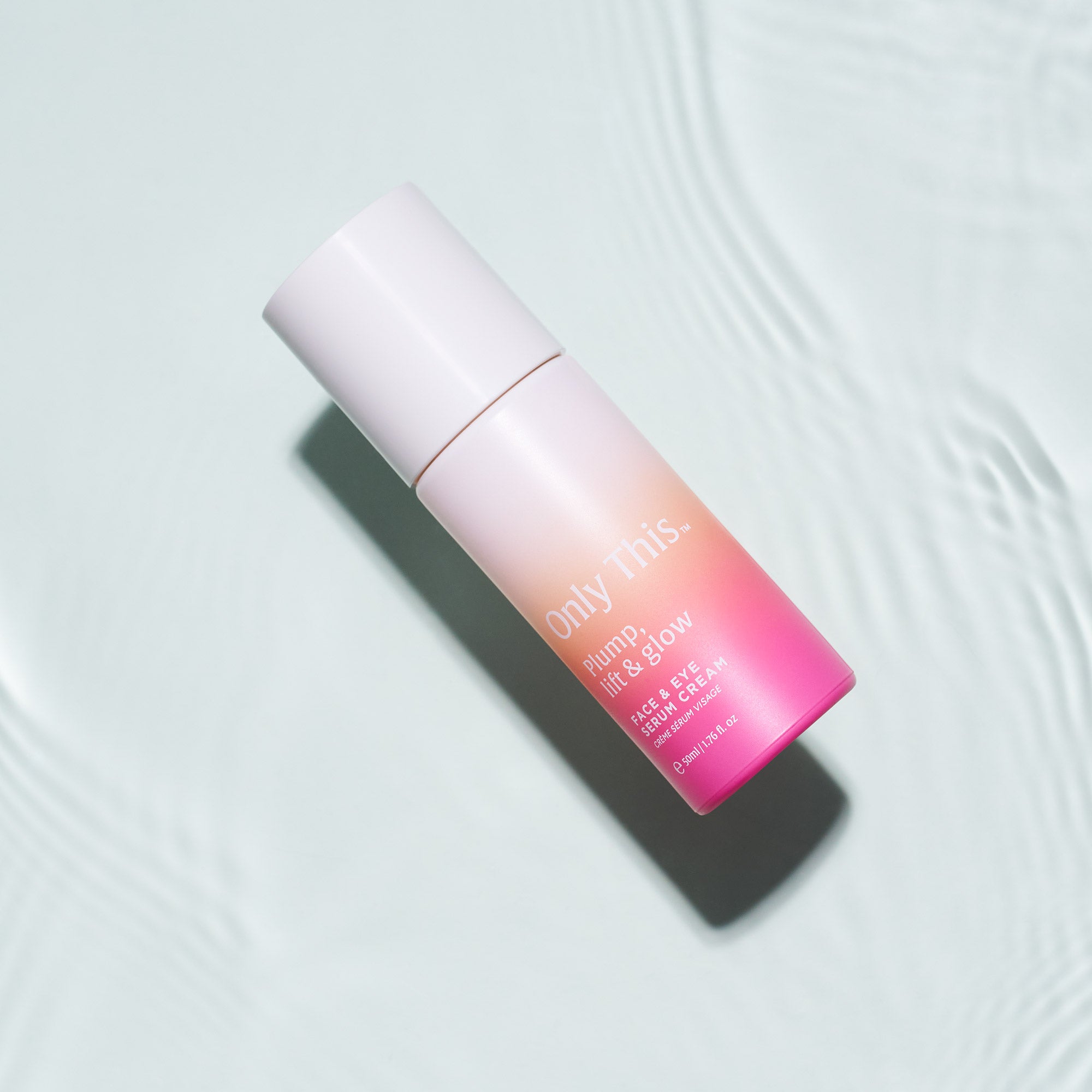 Skincare bottle with gradient design on a light background